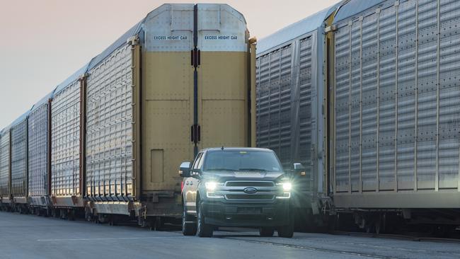 Linda Zhang, chief engineer of the Ford F-150, shows the capability of a prototype all-electric F-150 by towing 10 double-decker rail cars and 42 2019-model year F-150s, weighing more than 500 kilograms. Picture: Supplied.