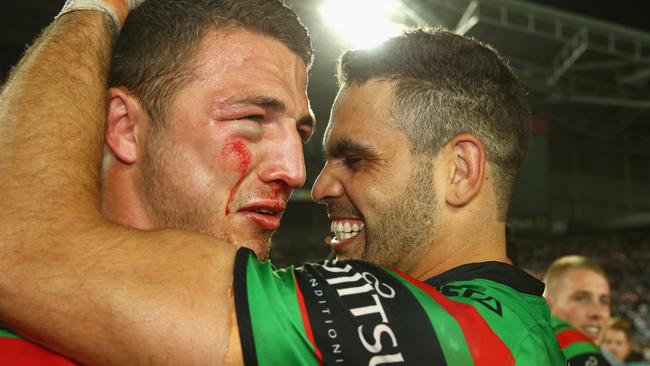 A bloodied Sam Burgess is congratulated by Greg Inglis.