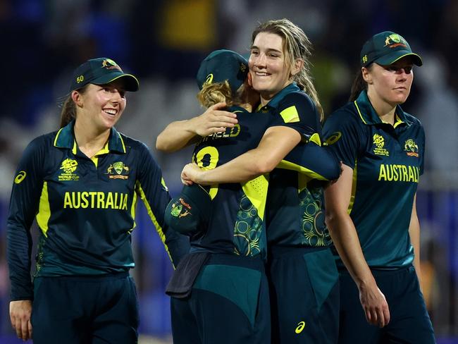 SHARJAH, UNITED ARAB EMIRATES - OCTOBER 13: Australia players celebrate winning the ICC Women's T20 World Cup 2024 match between India and Australia at Sharjah Cricket Stadium on October 13, 2024 in Sharjah, United Arab Emirates.  (Photo by Francois Nel/Getty Images)