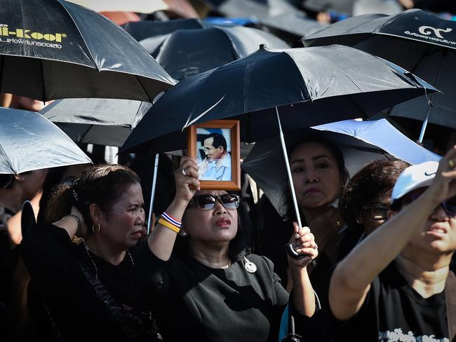 A woman holds aloft an image of the late Thai King Bhumibol Adulyadej during the final dress rehearsal for his funeral in Bangkok. Picture: AFP