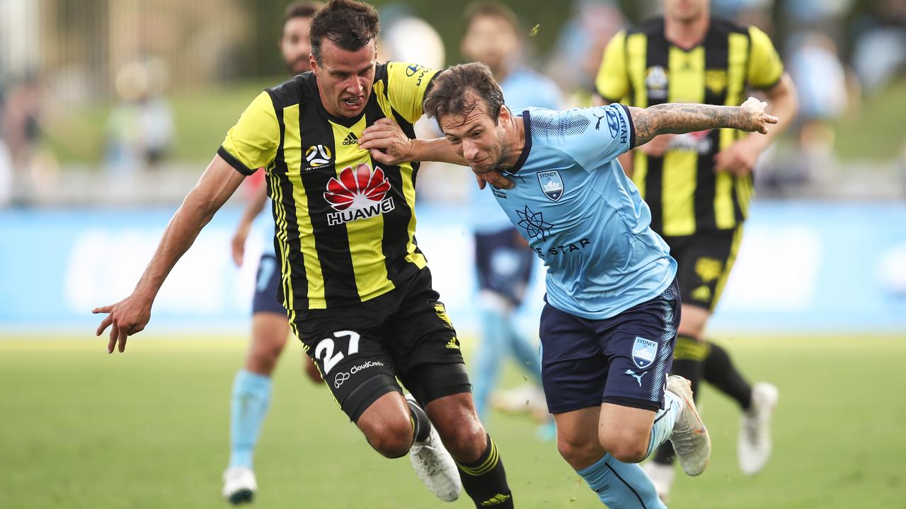 Adam Le Fondre of Sydney competes with Steven Taylor of the Phoenix