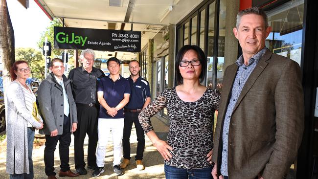 Business owners Rosa Constable, Angelo Karalis, Michael Sunderland, John Gu, Adam Toth with Lily Zheng and Mark Williams pose for a photograph at Mt Gravatt Central (AAP image, John Gass)