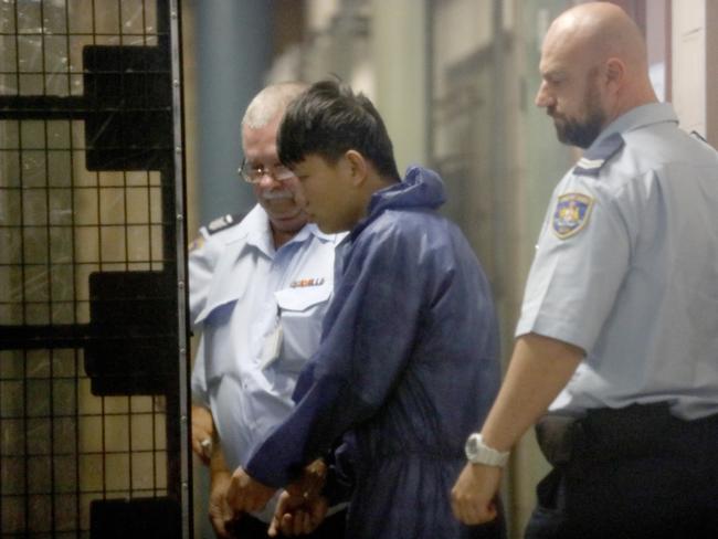 A man believed to be Shuo Dong, Ms Yu’s roommate, is led to a prison van at Burwood Local Court on June 13. Picture: AAP Image/Chris Pavlich