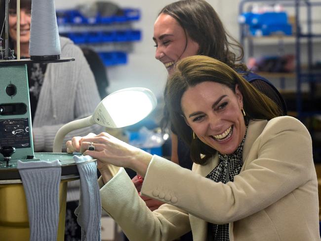 Catherine, Princess of Wales (C) shares a joke with members of the production team on the factory floor during a visit to Corgi, a family run textiles manufacturer. Picture: AFP