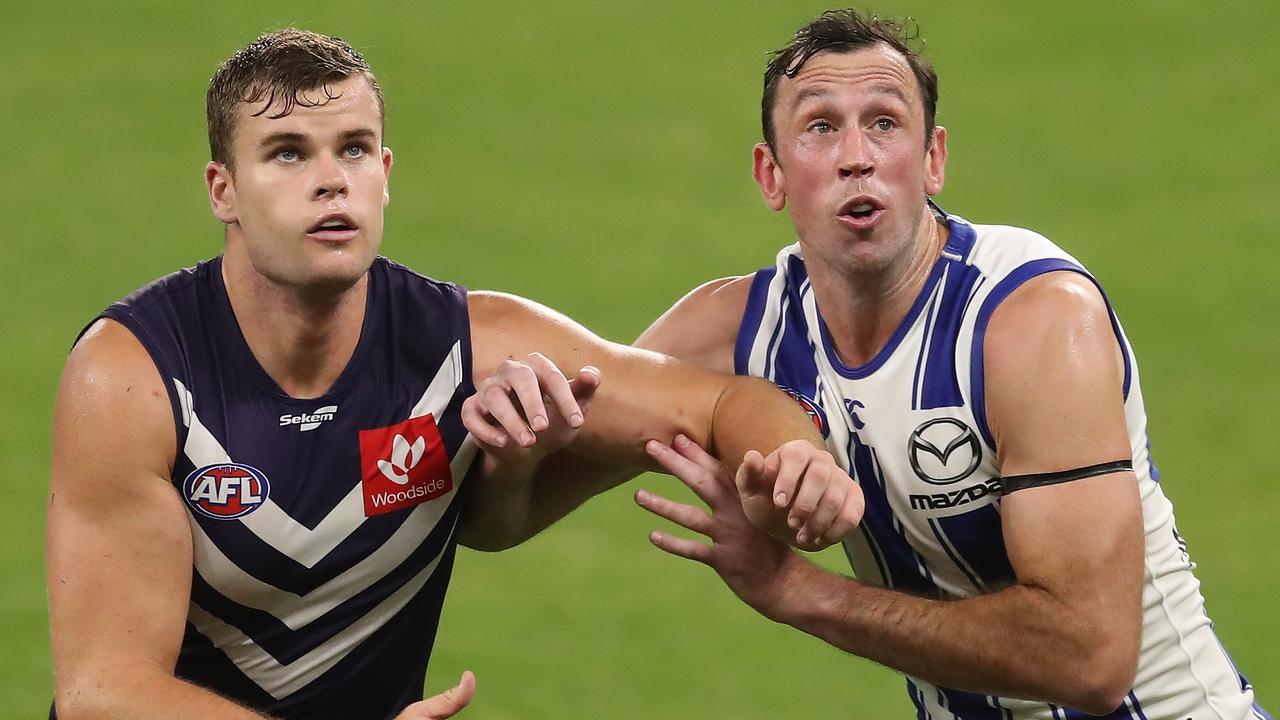 PERTH, AUSTRALIA - APRIL 24: Sean Darcy contests a ruck with Todd Goldstein during the 2021 AFL Round 06 match between the Fremantle Dockers and the North Melbourne Kangaroos at Optus Stadium on April 24, 2021 in Perth, Australia. (Photo by Will Russell/AFL Photos via Getty Images)