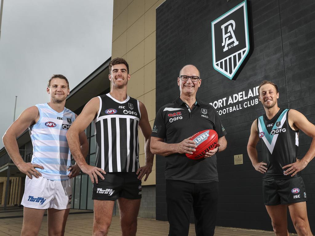 David Koch and several Port Adelaide players show off the new look.