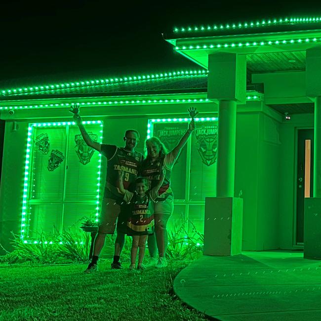 David with wife Tanita and daughter Grace 5. David Szoka of Hobart who has lit up his home in green to support the Tasmania JackJumpers. Picture: David Szoka