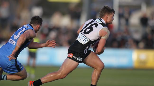 Port's Ollie Wines breaks away from Sturt star Aidan Riley. Picture: AAP Image/Dean Martin