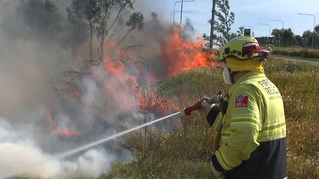 A firefighter tackles the large grass fire. Picture: TNV