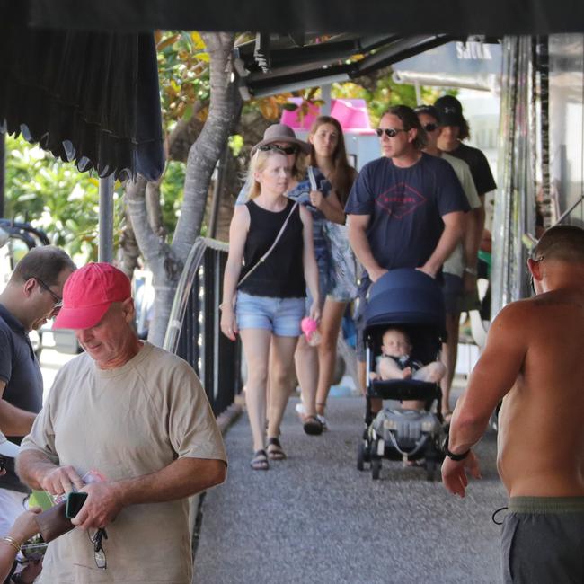 Pedestrians pound the pavement at Tedder Ave on Tuesday afternoon. Picture: Glenn Hampson