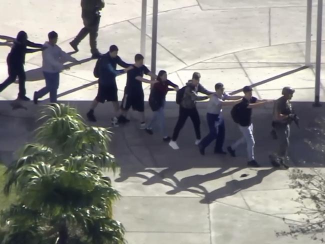 Students evacuate the school in single file. Picture: WPLG-TV via AP