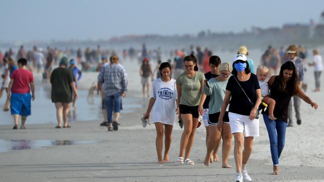 People walk down Jacksonville Beach, Florida. Picture: Getty Images