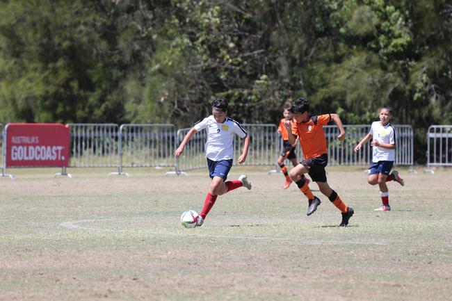 The Premier Invitational football tournament on the Gold Coast. Brisbane Roar Orange v TFC Brisbane White under-13s in action. Picture: Mike Batterham.