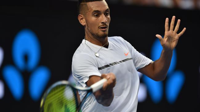 Nick Kyrgios hits a return against Gastao Elias during their men's singles first round match on day one of the Australian Open.