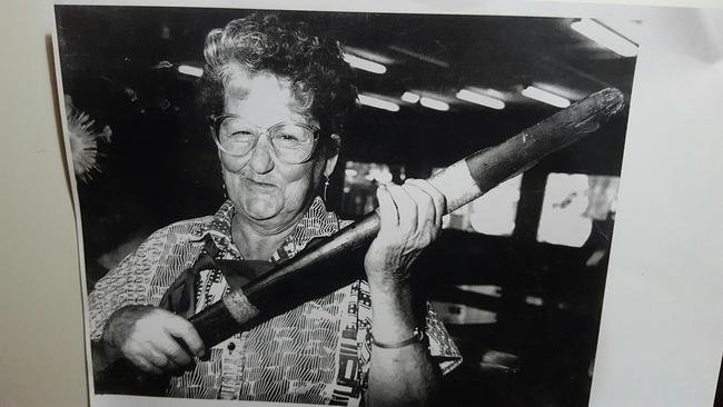 Dottie Darwen with her infamous tribal waddy which she called the "peacemaker" and used to control troublemakers at the bars she worked. It was originally presented to her by an Indigenous man who came into the Criterion Hotel. Picture: Supplied