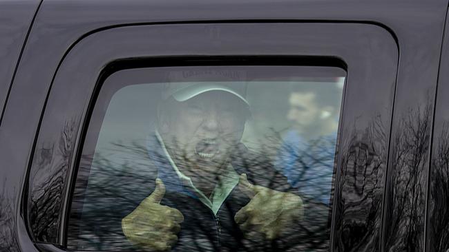 Donald Trump gives the thumbs up to supporters as he leaves his golf club in Sterling, Virginia, on Monday. Picture: AFP