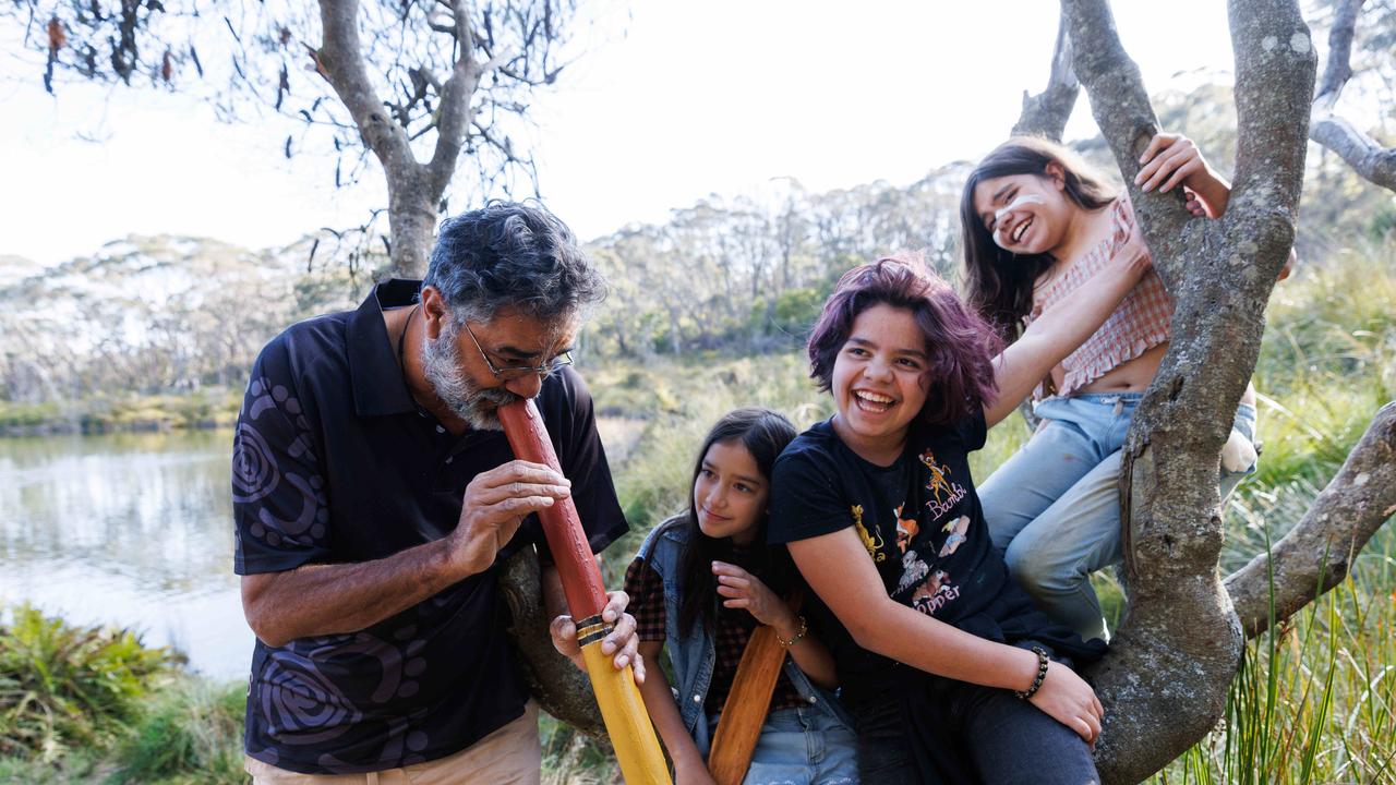 Uncle Peter Williams ssahres his culture with his children Joowal, 9, and Yulubirki, 11, and Miki May, 11/ Picture: David Swift