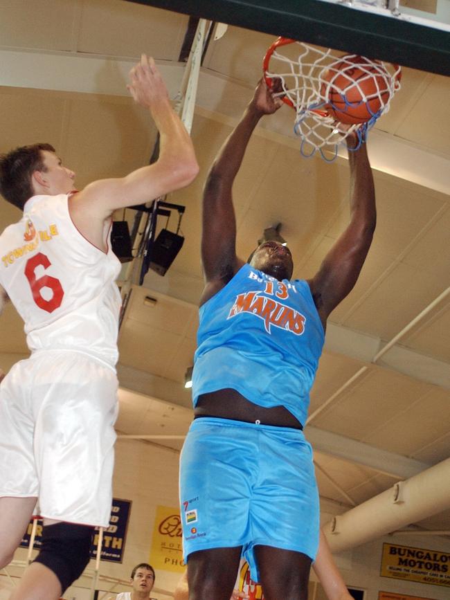 Cairns Marlin Nathan Jawai (right) dunks over Townsville's Todd Alloway. Picture: Pasco Rogato