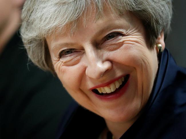 Britain's Prime Minister Theresa May reacts during her visit to the Scottish Leather Group Limited in Bridge of Weir in Scotland on November 28, 2018. - British MPs will hold a crucial vote on December 11 to approve or reject the Brexit deal agreed with EU leaders, Prime Minister Theresa May announced earlier this week. (Photo by RUSSELL CHEYNE / POOL / AFP)