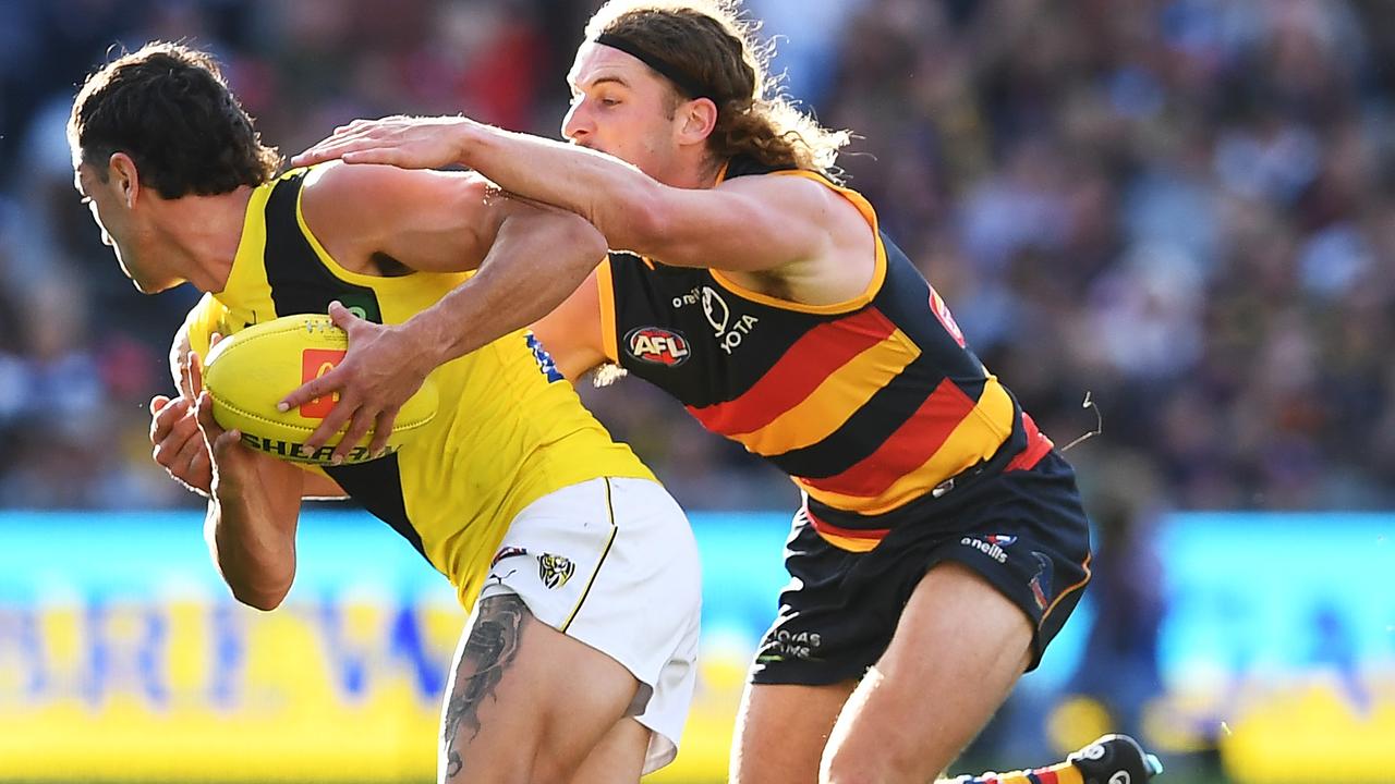 Sam Berry wraps up Richmond’s Tim Taranto at Adelaide Oval. Picture: Mark Brake/Getty Images