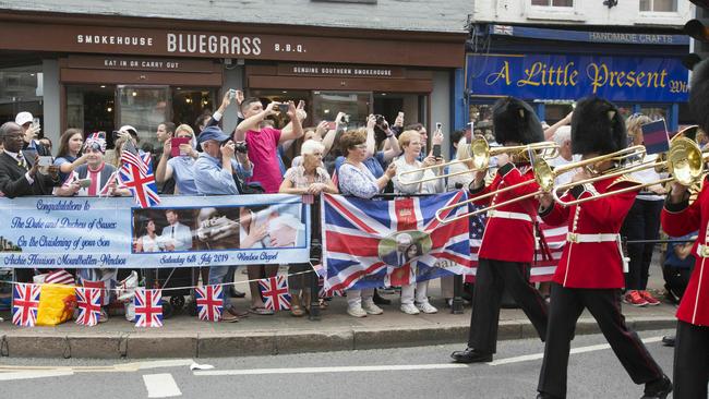 Visitors take pictures as the Changing of the Guard takes place, ahead of the royal christening.