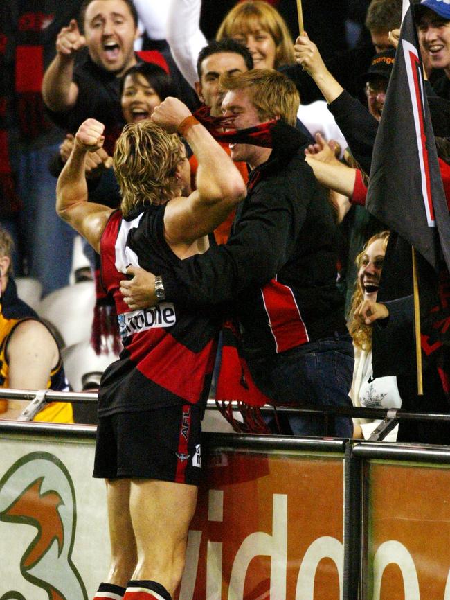 James Hird celebrates his winning goal with fan Drew Wilson.