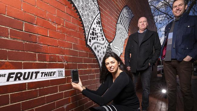 Croydon Main Street Traders Association’s Marta Makkai and artists Roger Archbold and Andy Drewitt with their innovative new street piece, The Fruit Thief, in Croydon’s Main St. Picture: DANIEL POCKETT.