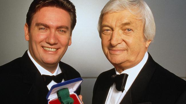 Eddie McGuire with cricket commentator Richie Benaud holding the Allan Border Medal.