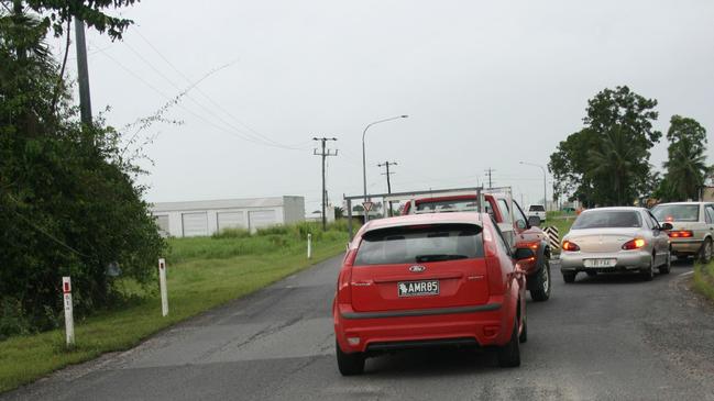 Drivers navigate massive potholes on the Bruce Highway, near Babinda