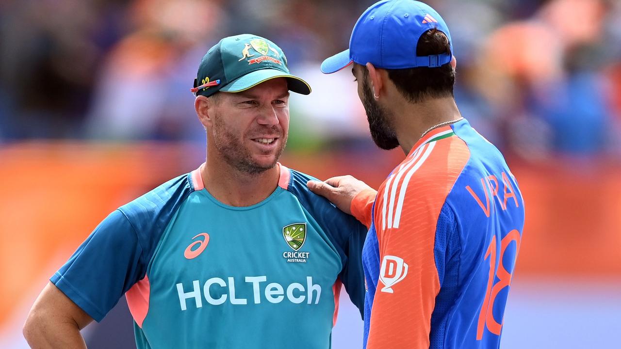 David Warner (left) is congratulated by Virat Kohli after his final match for Australia at last month’s T20 World Cup – unless his Champions Trophy hopes are answered. Picture: Gareth Copley / Getty Images