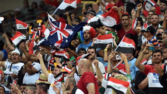 Iraq's fans celebrate after their team scored against Jordan during the first round Asian Cup football match between Jordan and Iraq at the Suncorp Stadium in Brisbane on January 12, 2015. AFP PHOTO / Saeed KHAN IMAGE RESTRICTED TO EDITORIAL USE - STRICTLY NO COMMERCIAL USE