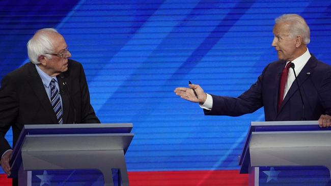 Bernie Sanders listens as Joe Biden argues his policies. Picture: AP.