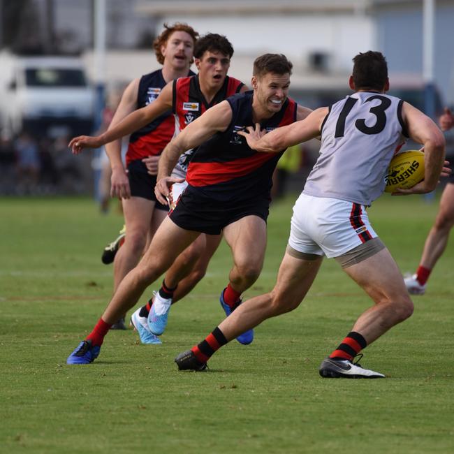 Bairnsdale coach, Logan Austin, attempts to tackle Maffra forward, John Butcher, last year. Picture supplied: Bairnsdale Advertiser