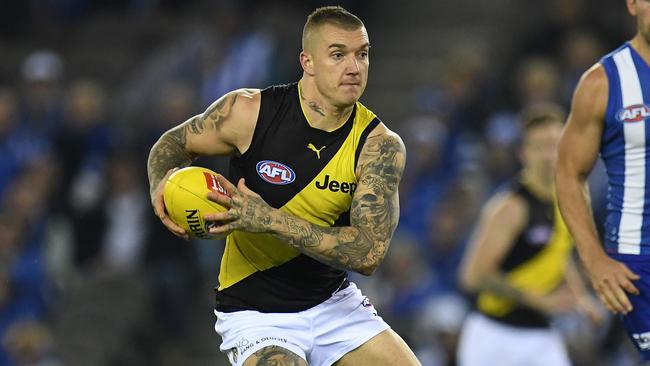 Dustin Martin of the Tigers (left) is seen in action during the Round 11 AFL match between the North Melbourne Kangaroos and the Richmond Tigers at Etihad Stadium in Melbourne, Saturday, June 3, 2017. (AAP Image/Julian Smith) NO ARCHIVING, EDITORIAL USE ONLY