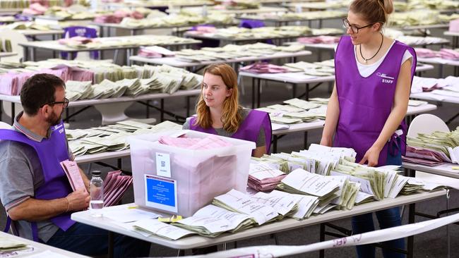 Workers sort through absentee ballot papers in Sydney on July 5. Picture: William West/AFP