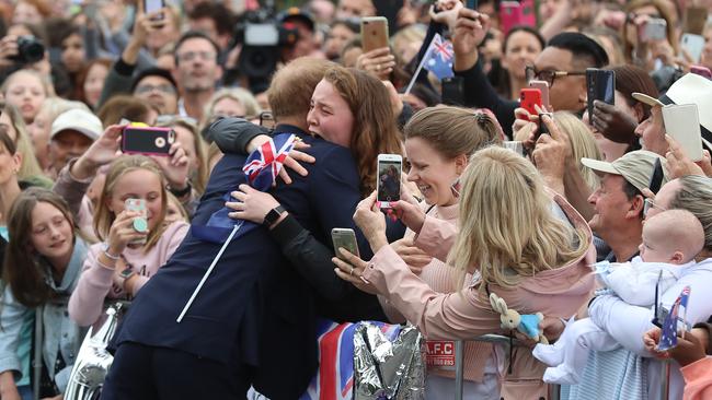 India Brown, 19, gets a hug from Prince Harry. Picture: Alex Coppel