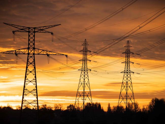 This photograph taken on December 6, 2022, shows the poles of a very high voltage power line in Verfeil, southwestern France. - France may face "some days" this winter when insufficient electricity supply could mean power cuts, the head of French energy regulator RTE said on December 1, 2022, as the government briefed local authorities on how to manage any possible outages. (Photo by Lionel BONAVENTURE / AFP)