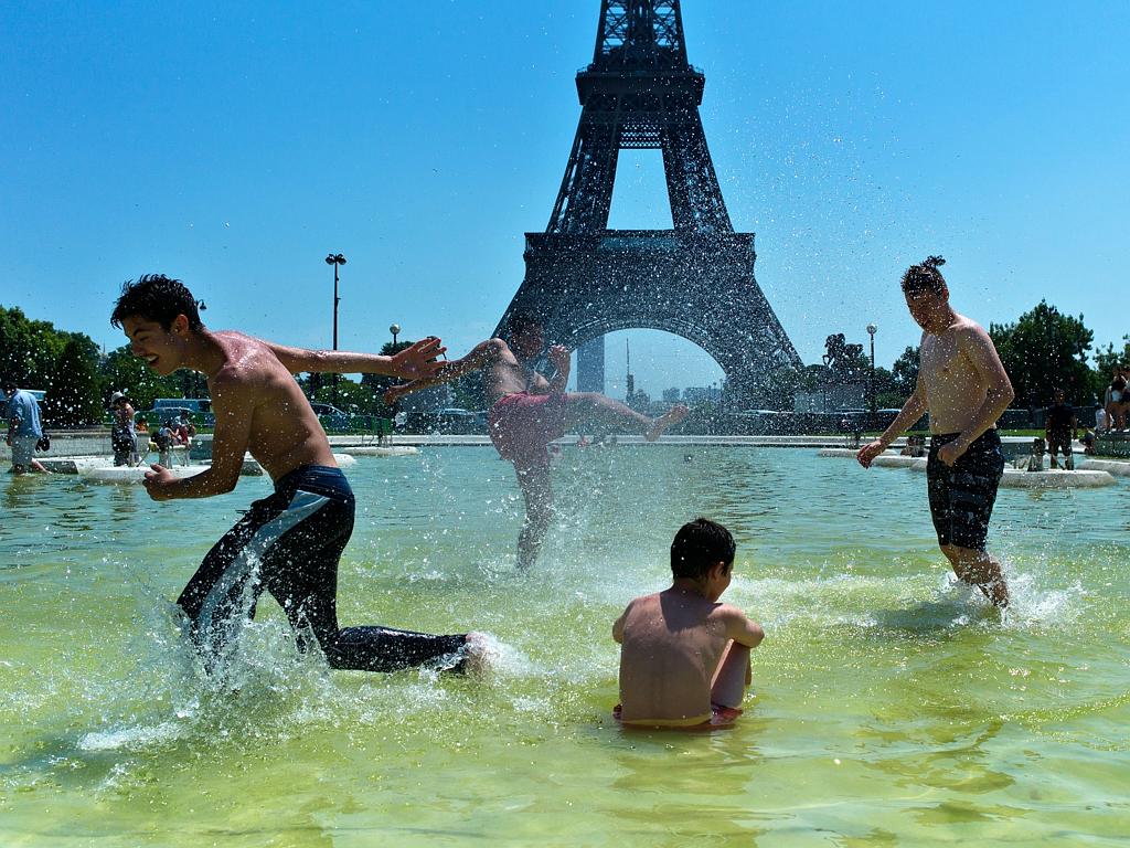 Boys play in the fountain of the Trocadero gardens, in front of the Eiffel Tower, in Paris, July 1, 2015. A mass of hot air moving north from Africa has driven up temperatures in Spain, Portugal, Britain and France in recent days. Picture: AP