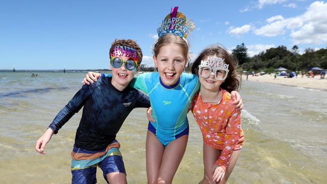 Reed Wilson, 9, and Isla and Frankie Ostle, 9 and 7, cool off at Kyeemagh Beach ahead of New Year’s Eve. Picture: Richard Dobson