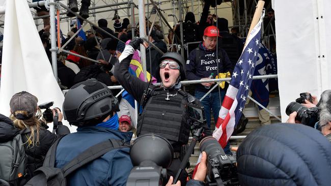 An armour-wearing man issues a rallying call to raid the Capitol building as Trump supporters clash with police. Picture: AFP