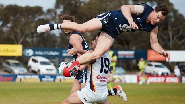 South Adelaide’s Anthony Biemans fliews over the top of Adelaide captain Matt Wright at Noarlunga Oval. Picture: Matt Loxton