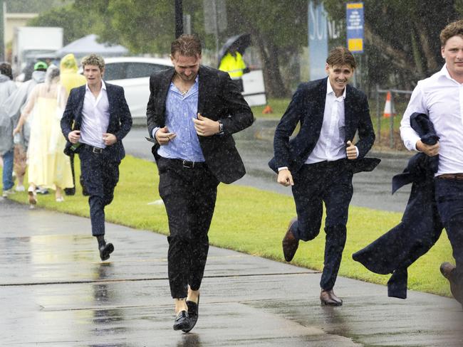 People leaving a wet Magic Millions Raceday at Gold Coast Turf Club, Saturday, January 11, 2025 - Picture: Richard Walker