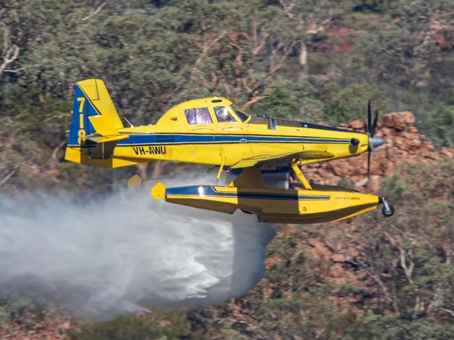 One of the 'Fire Boss' water bombers laying down a line to contain the grass fire. Picture: Mount Isa Aviation Photography