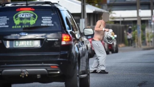 A man, who appears drug-affected, stops traffic in a Richmond street. Picture: Tony Gough