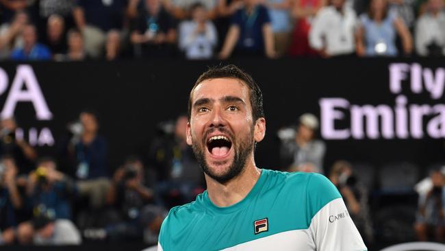 Croatia's Marin Cilic celebrates beating Britain's Kyle Edmund in their men's singles semi-finals match on day 11 of the Australian Open tennis tournament in Melbourne on January 25, 2018. / AFP PHOTO / SAEED KHAN / -- IMAGE RESTRICTED TO EDITORIAL USE - STRICTLY NO COMMERCIAL USE --