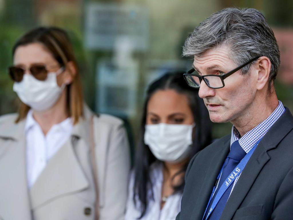 Detective Acting Senior Sergeant Graham Ross with the alleged victims on Friday. Picture: Tim Carrafa