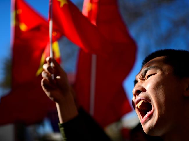 A Chinese man shouts slogans during a protest outside BBVA bank in Madrid. Picture: AFP