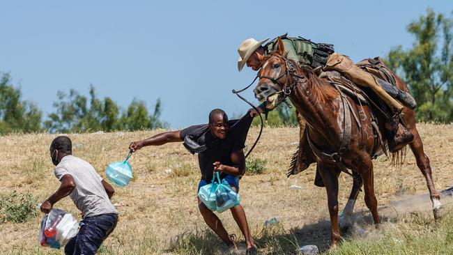 A United States Border Patrol agent on horseback tries to stop a Haitian migrant from entering an encampment on the banks of the Rio Grande near the Acuna Del Rio International Bridge in Del Rio, Texas in September, 2021. Picture: Paul Ratje/AFP