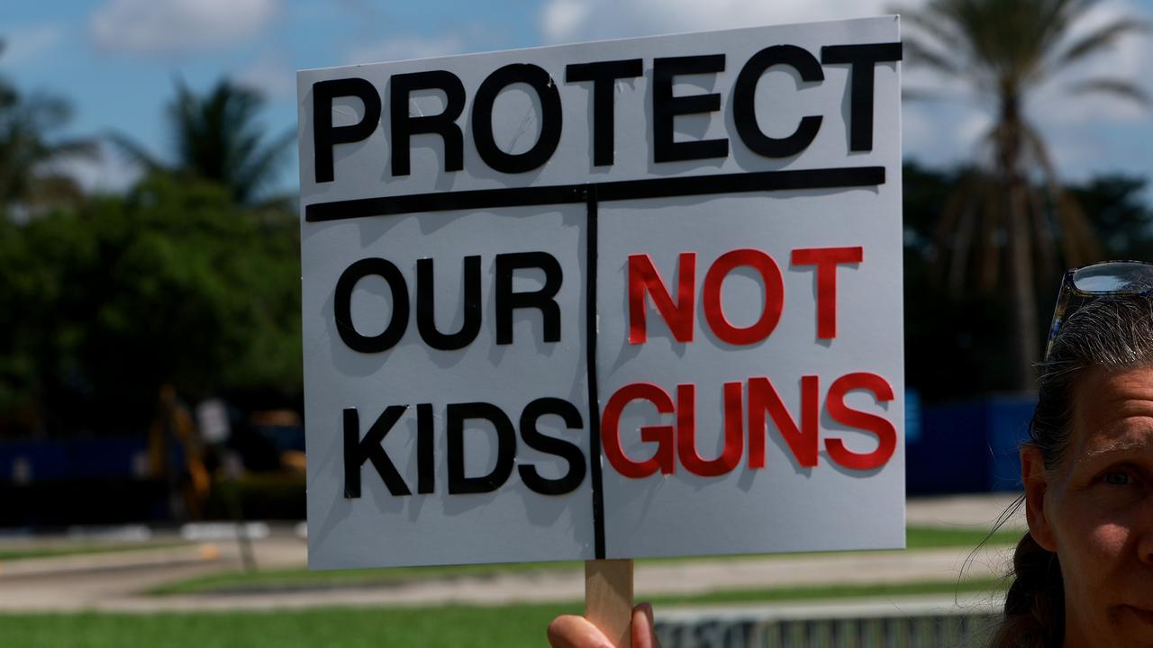 An activist poses with a sign in Florida after a devastating month of gun violence in the US. Picture: Joe Raedle/Getty Images/AFP