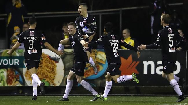 Joseph Gibbs of Blacktown City celebrates a goal with teammates.